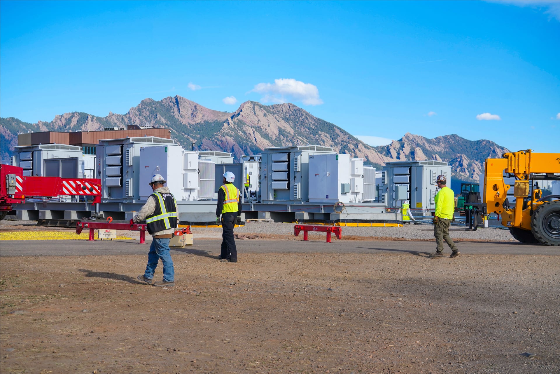 ON.energy power infrastructure installation with a field team and mountain backdrop